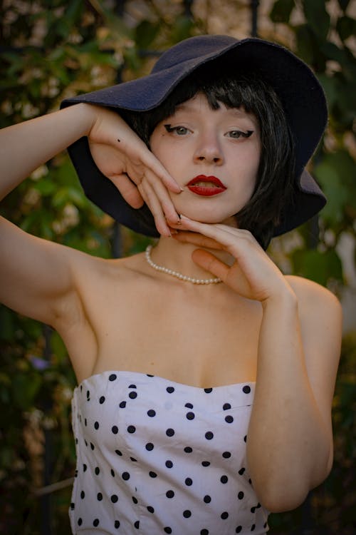 Young Woman in a Black Hat and Dotted Dress 