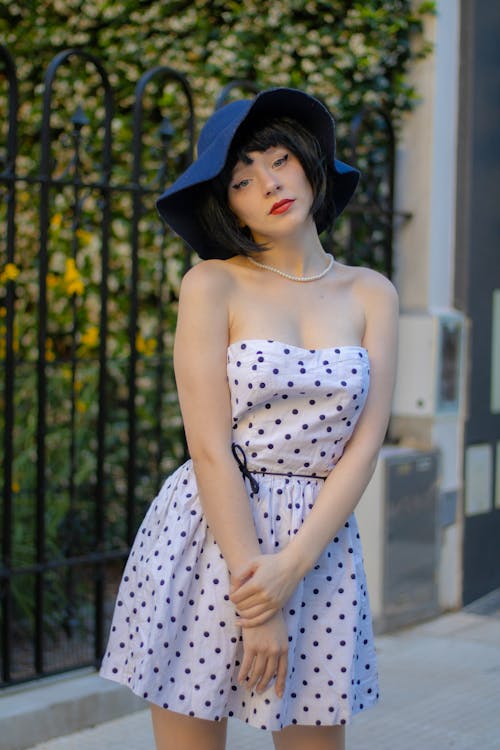 Young Woman in a Dotted Dress and a Hat 