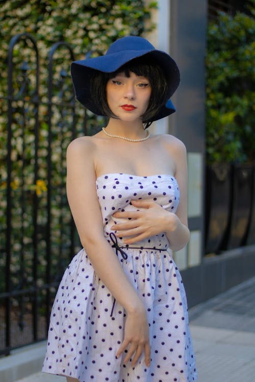 Woman in a Dotted Dress and a Black Hat 