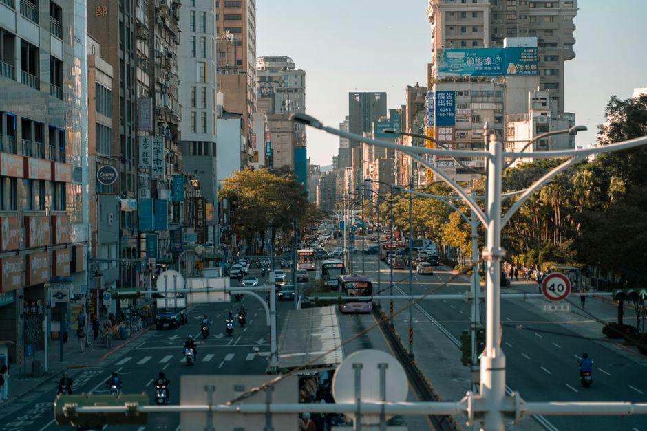 A busy street scene showcasing the vibrant urban life in a modern cityscape.