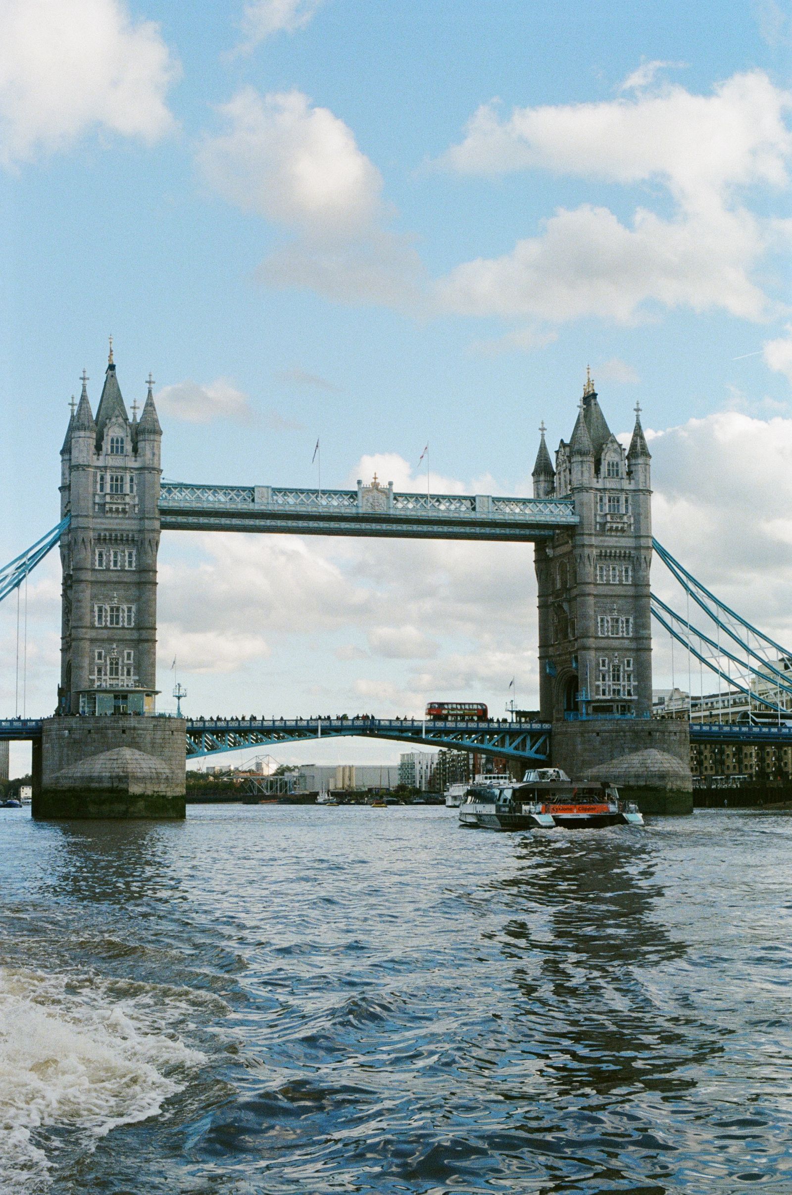Tower Bridge's twin stone towers spanning the Thames on a bright day