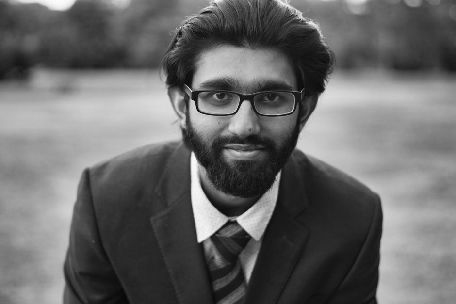 Elegant black and white portrait of a man with eyeglasses and a suit in an outdoor setting. Elegant black and white portrait of a man with eyeglasses and a suit in an outdoor setting.