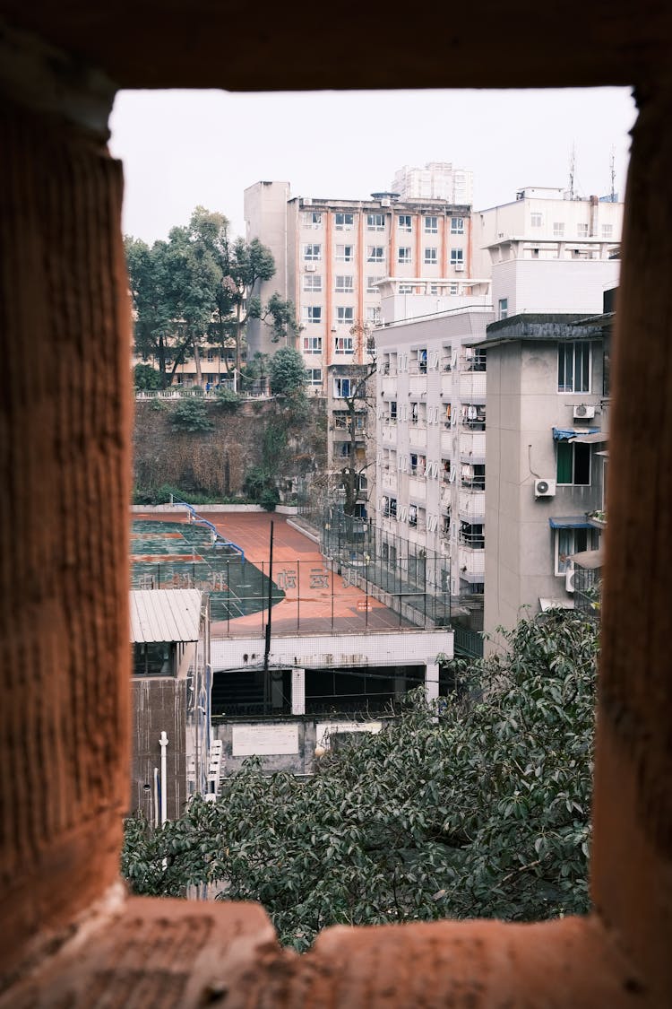 View Of Buildings And A Court In City From A Window 