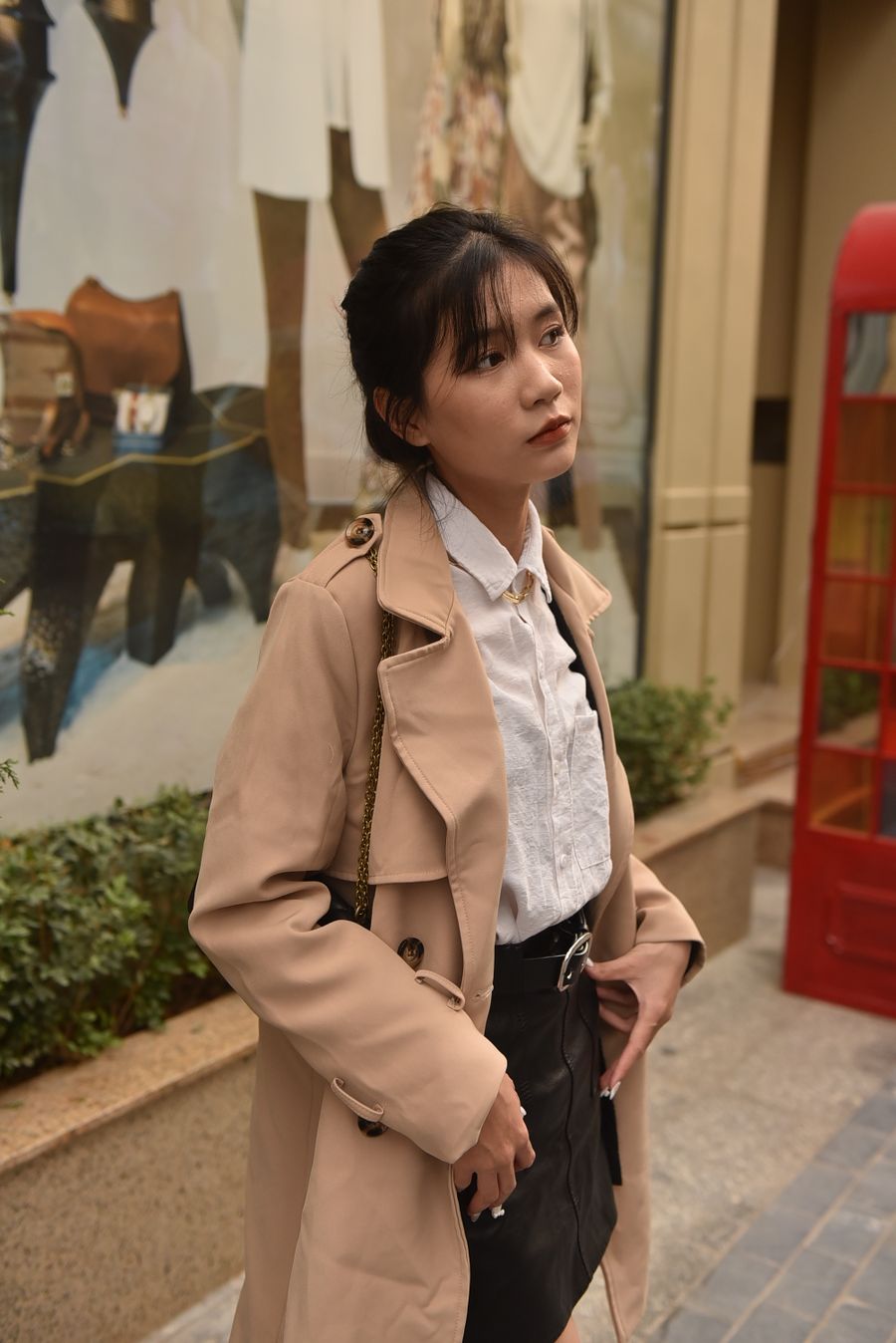 Woman in a beige trench coat on a city street — photo by Felix Young on Pexels