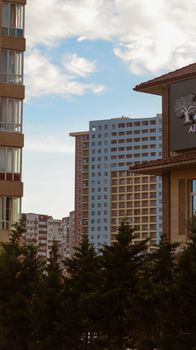Vertical shot of modern residential buildings in Baku, Azerbaijan, with a clear blue sky.