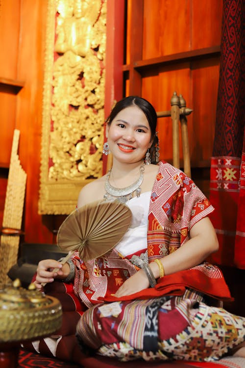 Portrait of Woman Wearing Traditional Asian Costume and Holding Range 