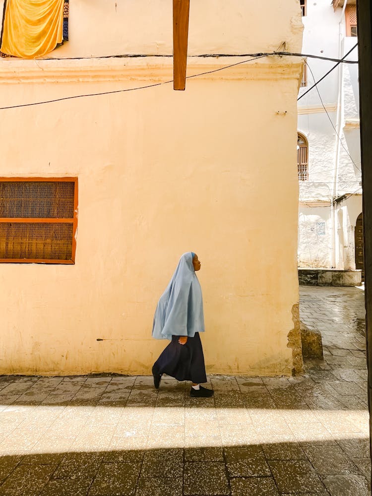 Woman In Traditional Clothes Walking On The Street