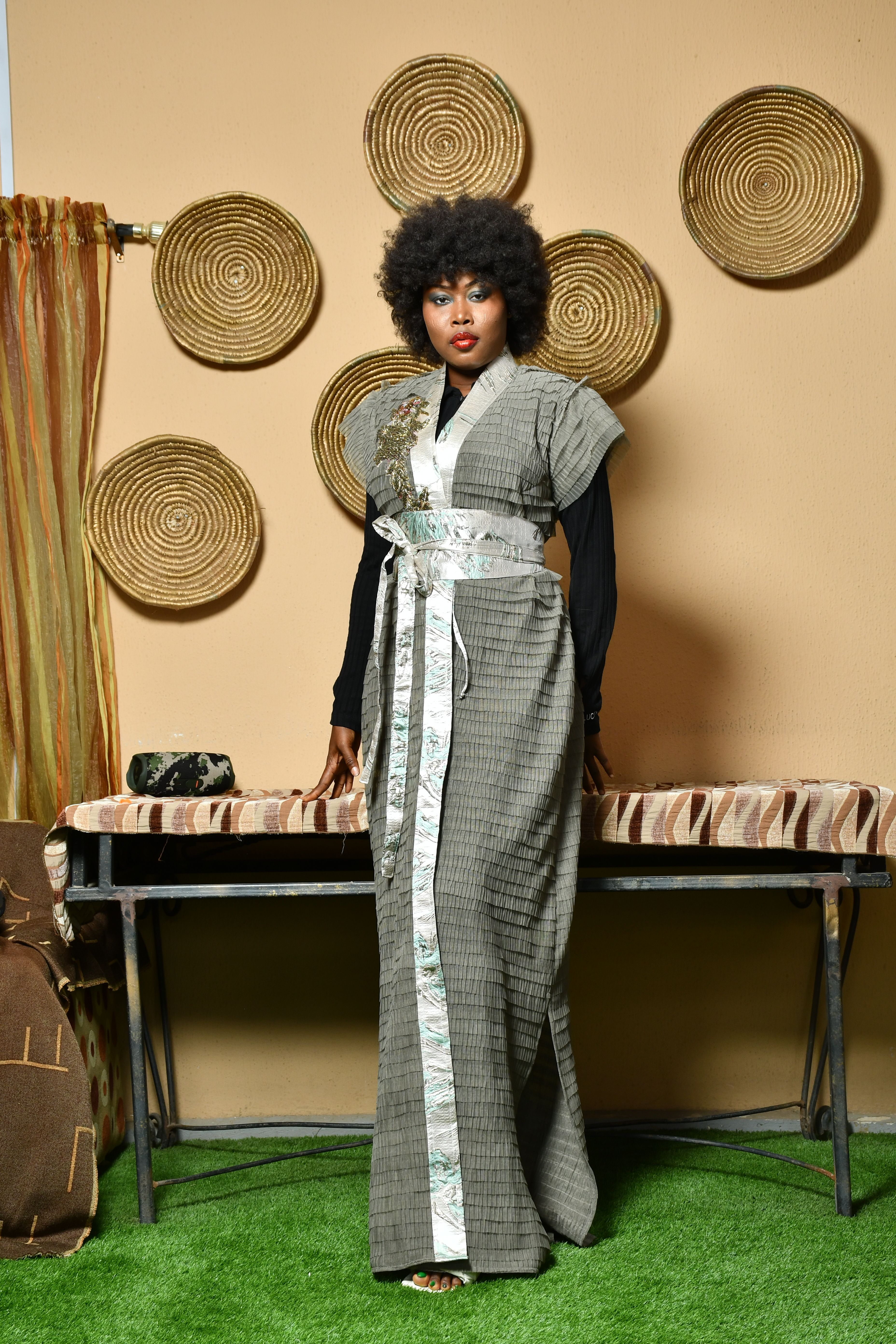 Model posing in a stylish traditional dress, showcasing fashion trends indoors.