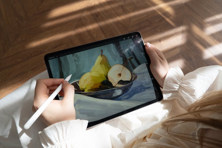 A Girl Drawing On A Tablet 