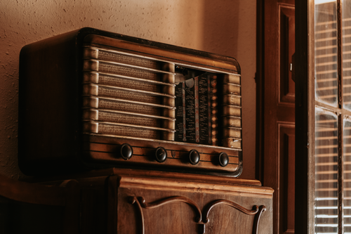 Free A classic vintage radio resting on a wooden cabinet in a cozy interior setting in Badajoz, Spain. Stock Photo