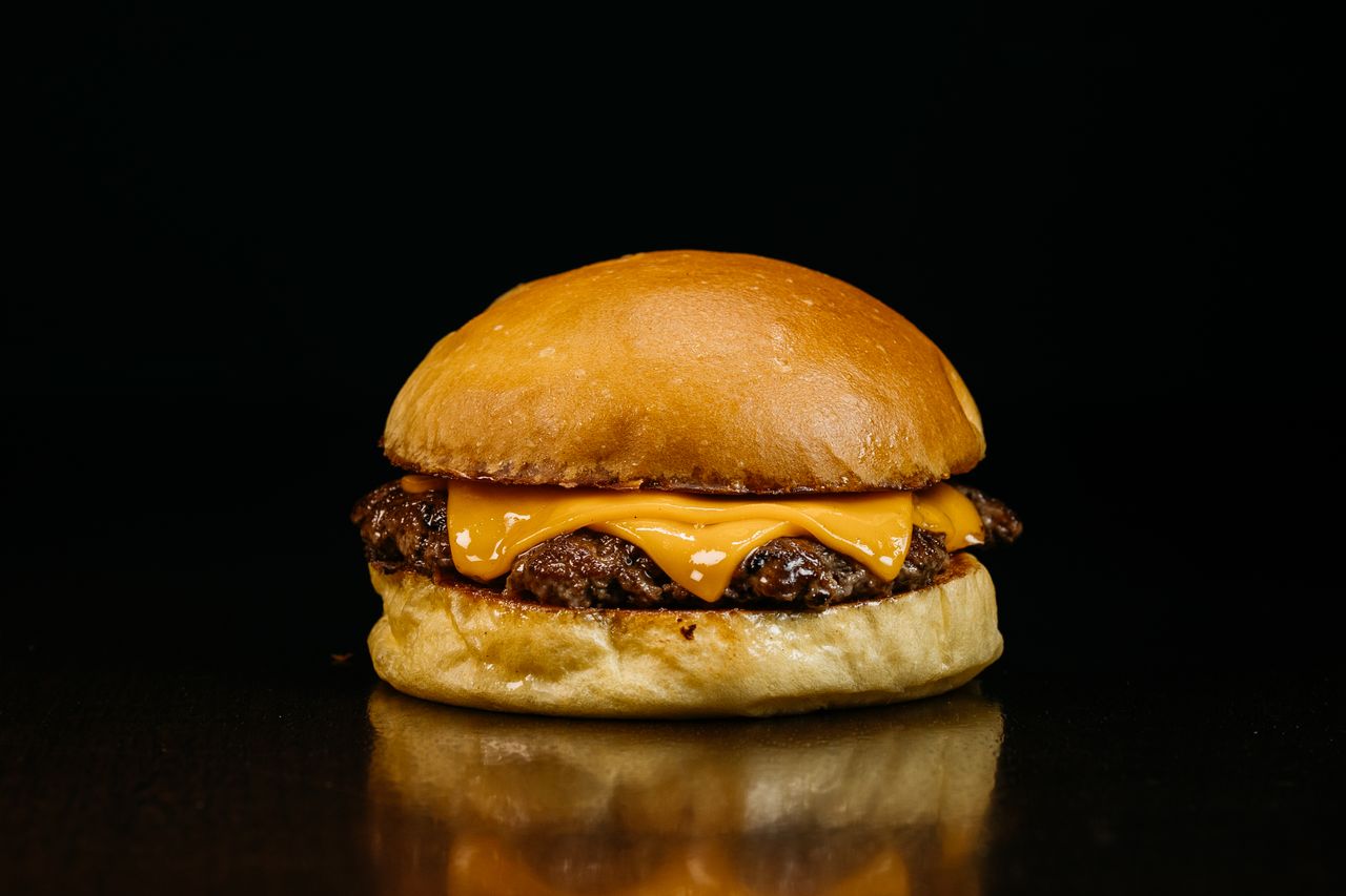 close up of a classic cheeseburger with melted cheese and beef patty o