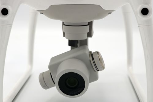 Free Close-up view of a drone camera, showcasing modern technology on a white backdrop. Stock Photo