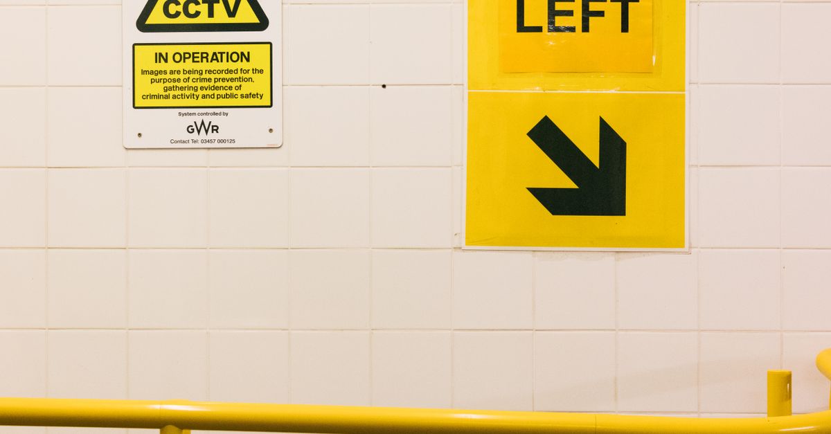 Information Signs on a Wall above a Yellow Railing · Free Stock Photo