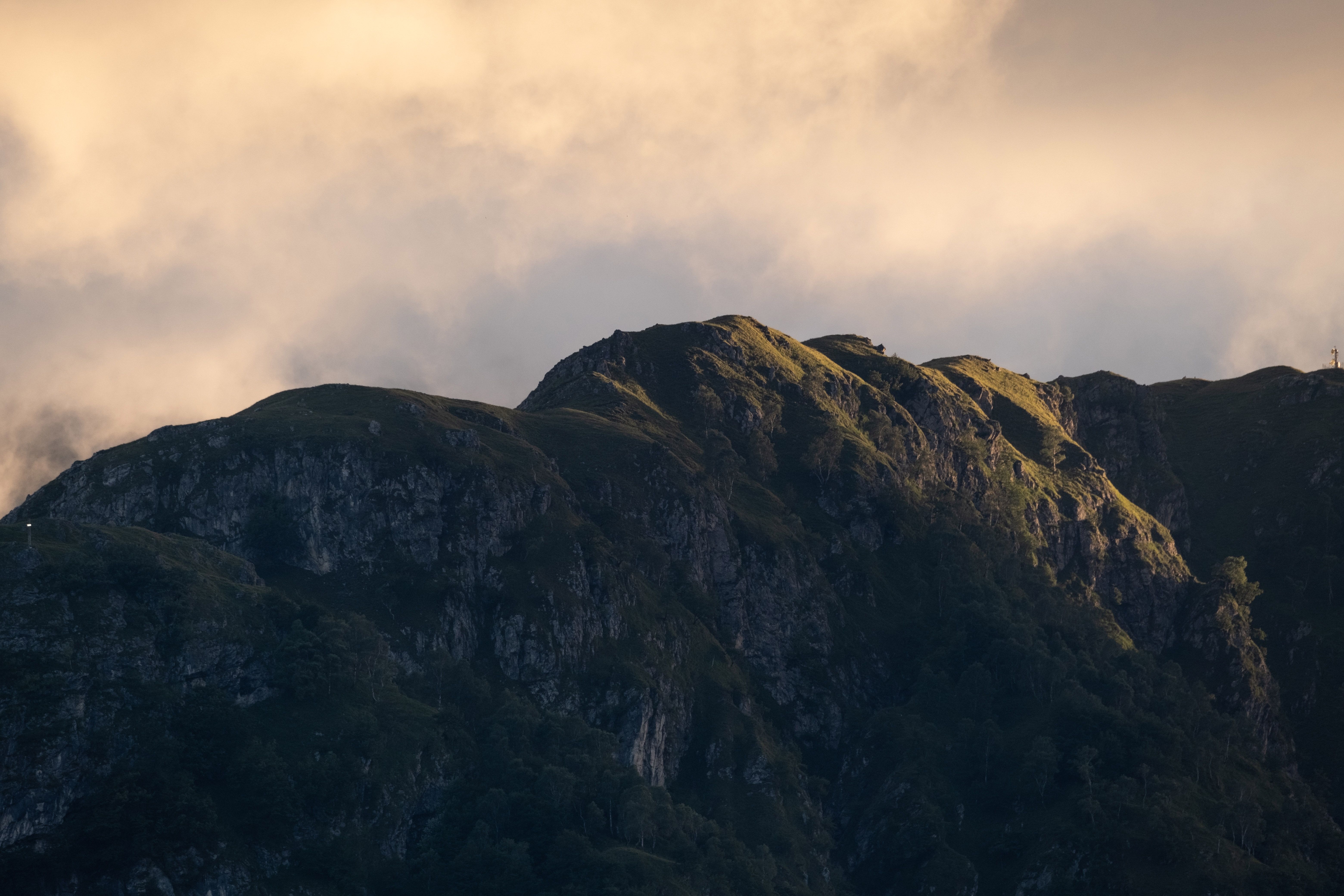 View of a Rocky Mountain under a Cloudy Sky · Free Stock Photo