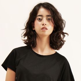 Model wearing a plain black t-shirt, photo by Visible Gain on Pexels