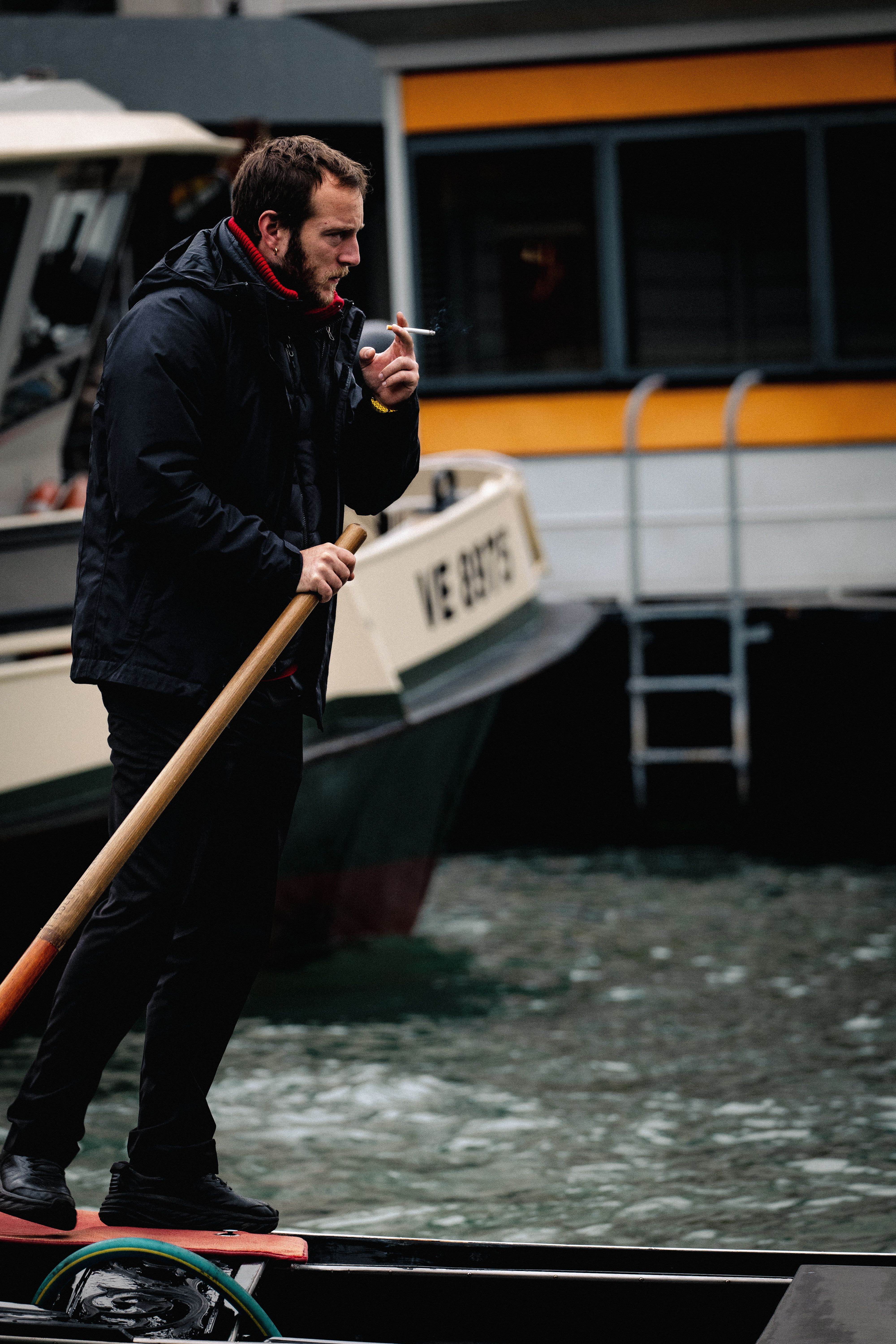 Bearded Gondolier Smoking Cigarette on Boat · Free Stock Photo