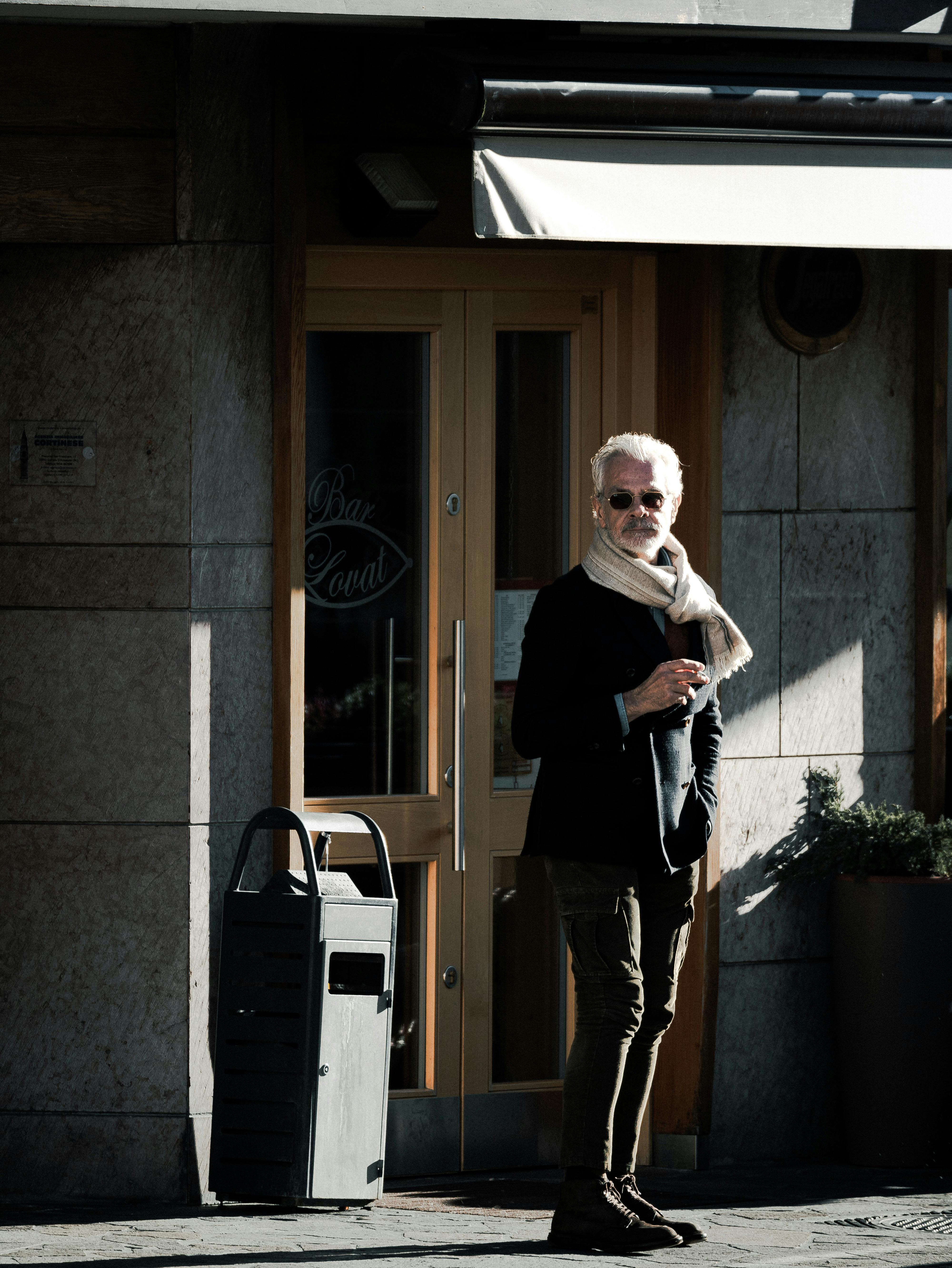 Man in Sunglasses Standing near Garbage Bin · Free Stock Photo