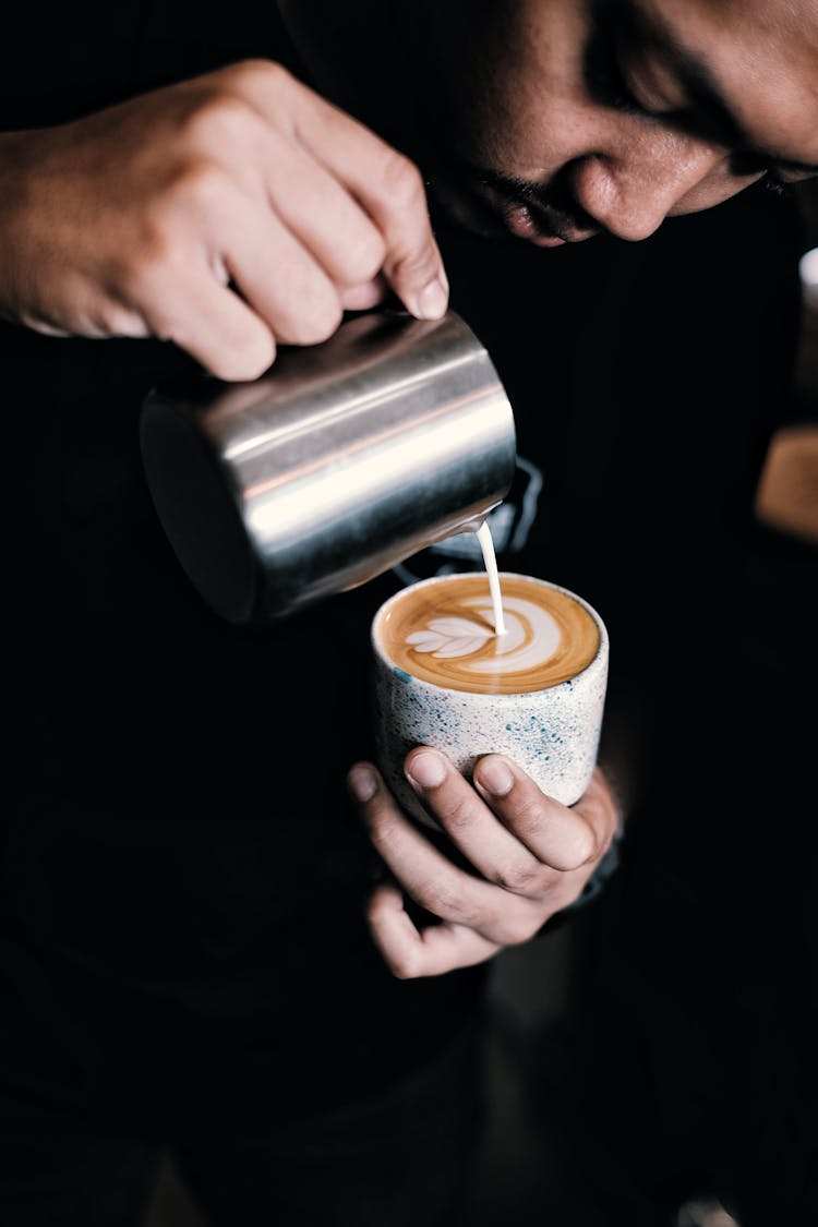 Man Pouring Coffee On Ceramic Mug