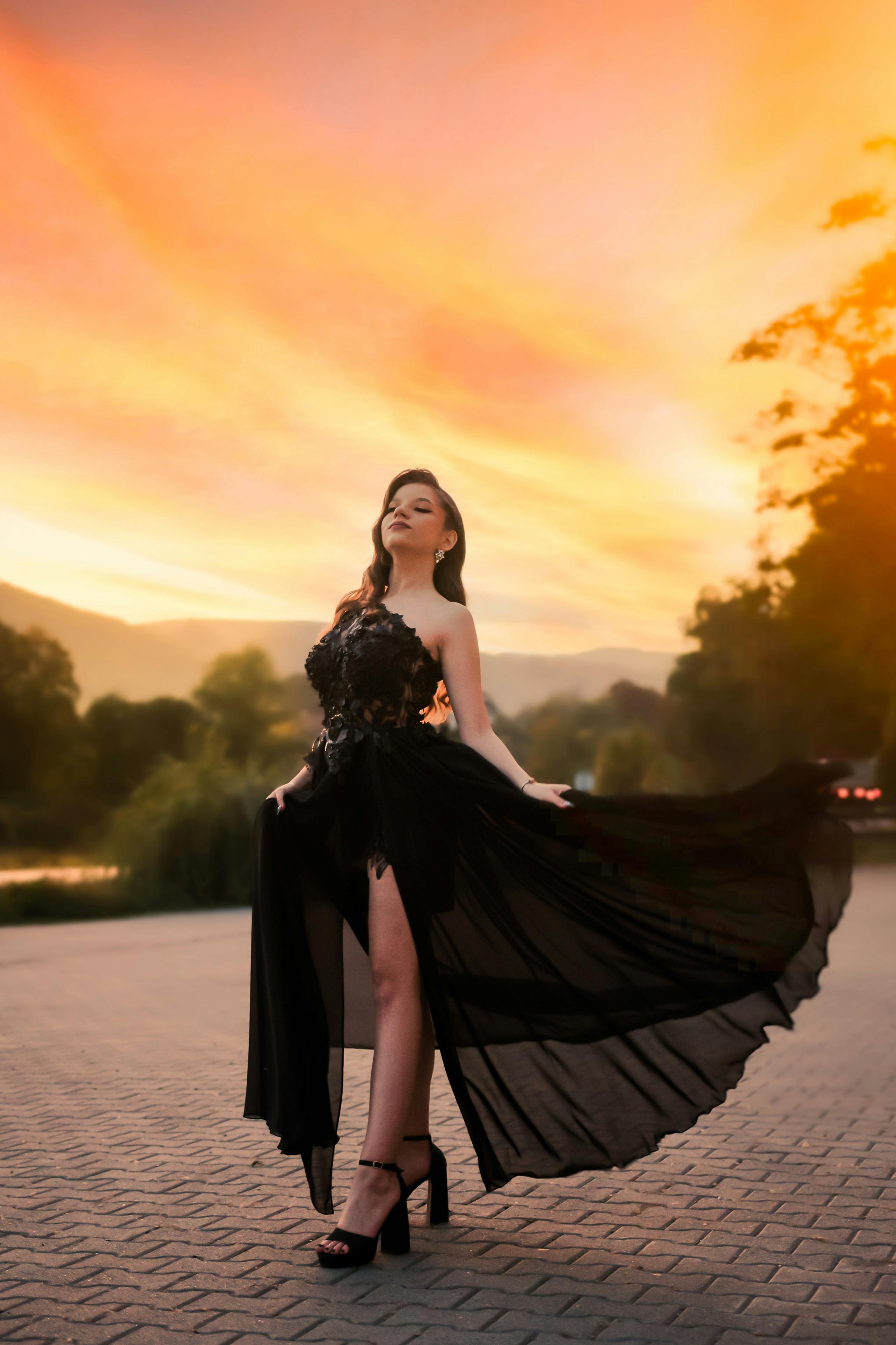 beautiful young brunette girl posing a road in the middle of the field at  sunset, silhouette 4052525 Stock Photo at Vecteezy