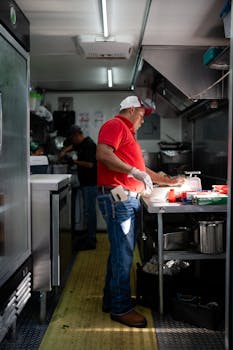 Two chefs actively preparing meals in a bustling restaurant kitchen with focus on teamwork and culinary skills.