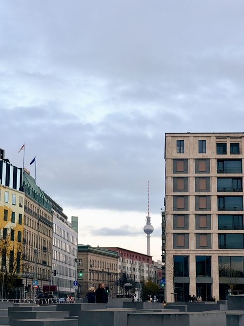 Free Distant view of Berlin's TV Tower amid urban buildings under overcast skies. Stock Photo