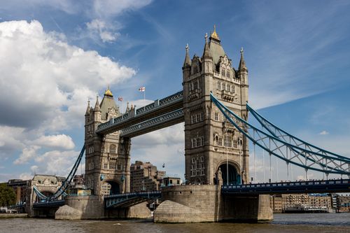 Free Iconic Tower Bridge spanning the River Thames in London under a blue sky. Stock Photo