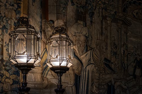 Dark Photograph of Wall with an Arras and Lanterns