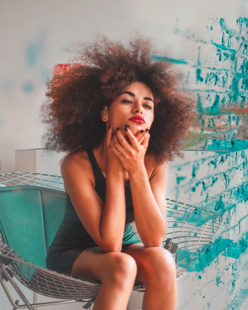 Woman Sitting on Green Moonchair