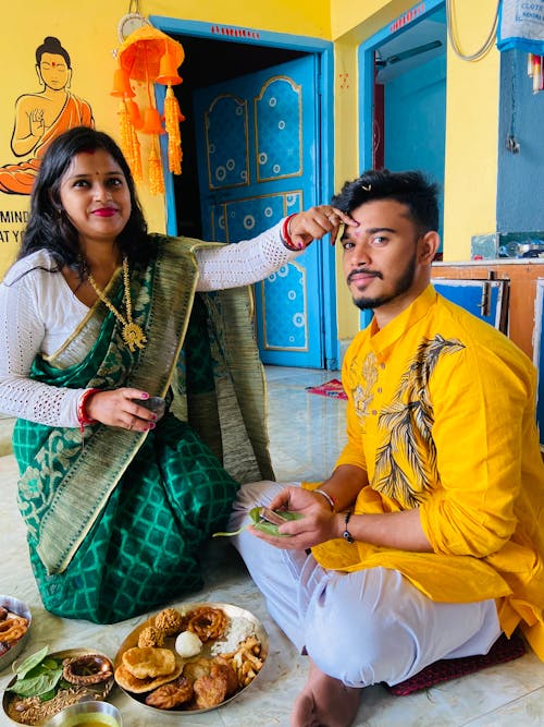 Traditional Indian Couple Eating in a Living Room