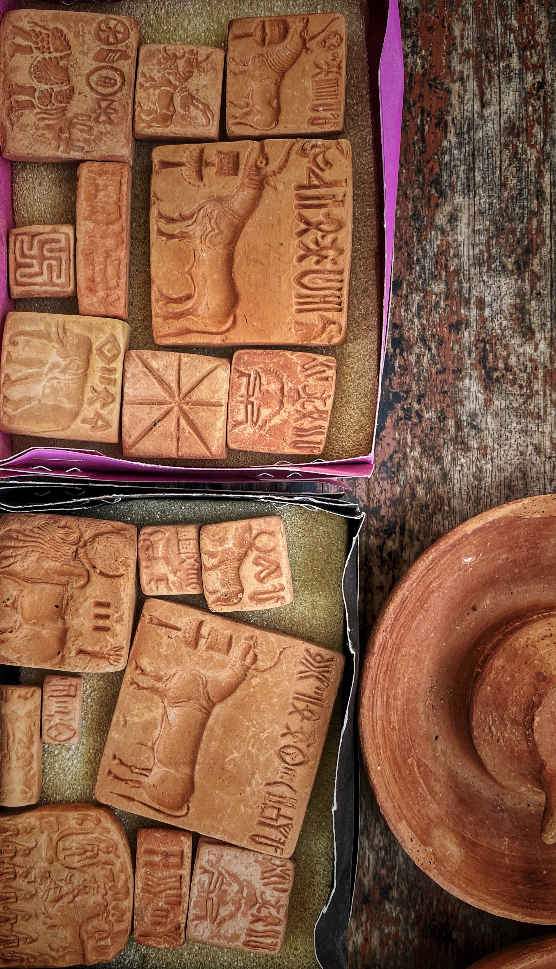 Top view of rustic clay plaques showcasing ancient patterns and designs.