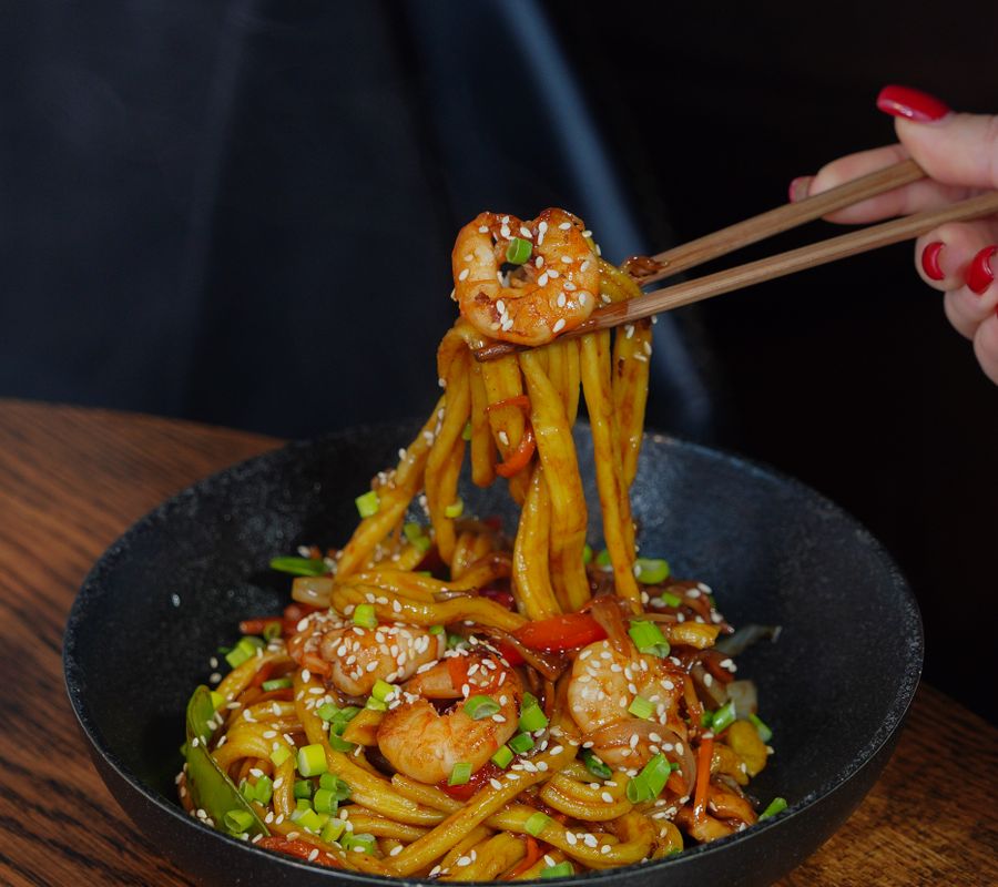 A delicious bowl of shrimp noodles captured with vibrant colors and textures.