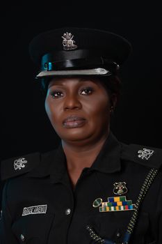 Professional portrait of a female police officer in official uniform against a dark background. - Fotografer Sidoarjo