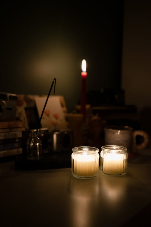 Burning Candles Standing on a Desk 