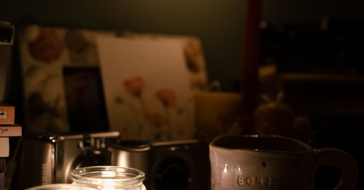 Warm interior shelving holding jars and bottles in soft light