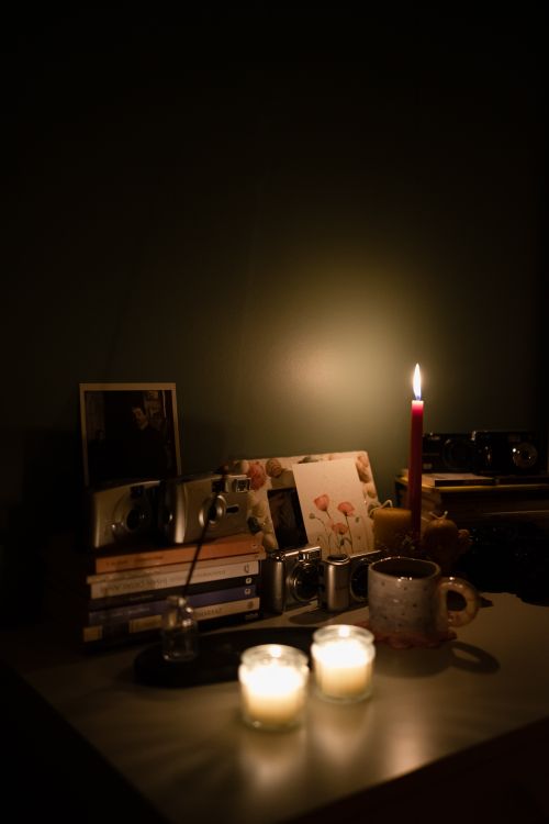 Free A warm and cozy desktop with books, candlelight, and a mug, creating a serene atmosphere in Ankara. Stock Photo