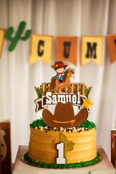 Vibrant cowboy-themed birthday cake with a topper featuring a cowboy and the name Samuel, perfect for a child's first birthday.