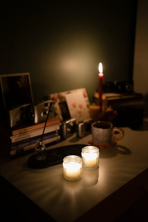 Burning Candles Standing on a Desk 