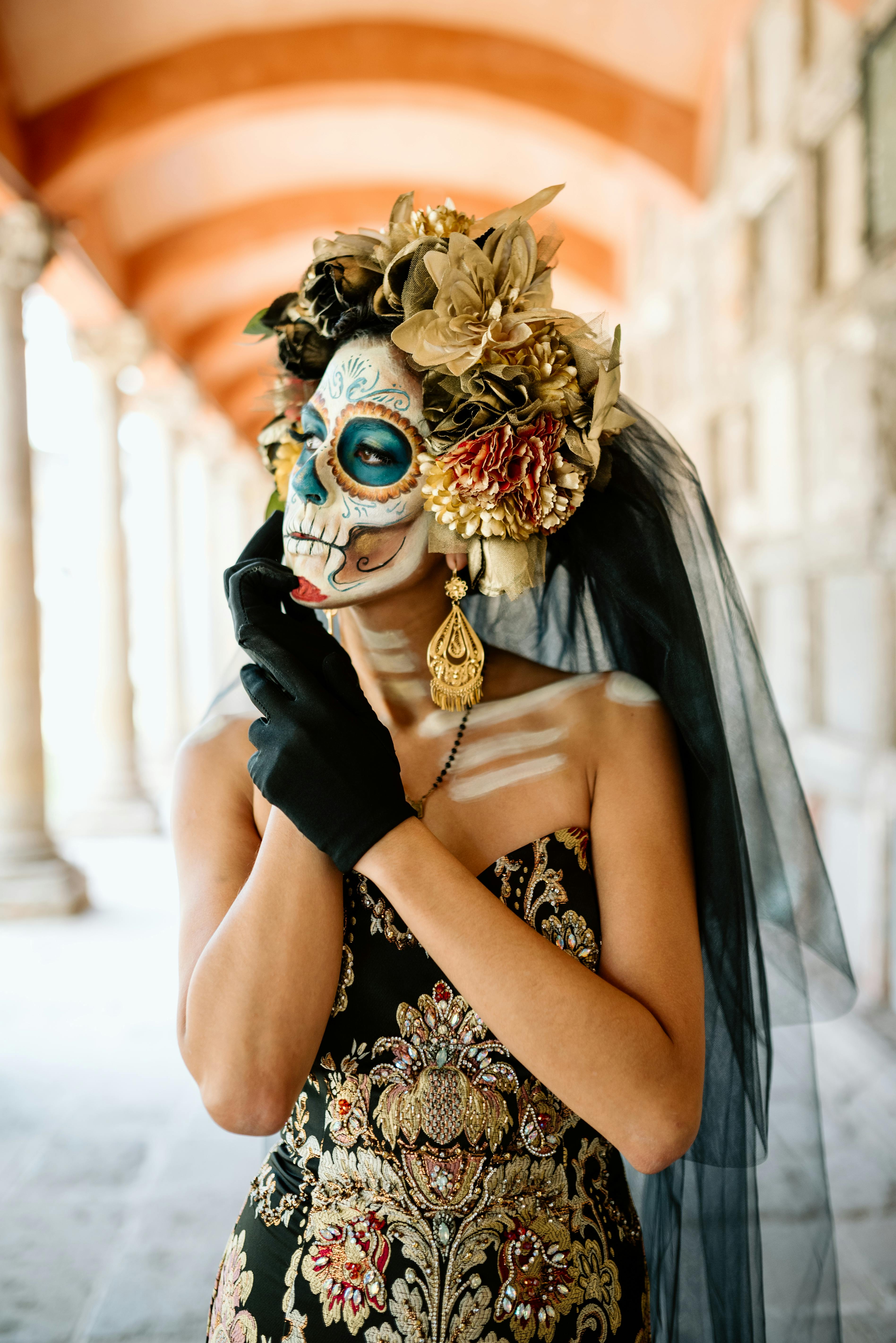 woman in a costume and makeup for the day of the dead celebrations in mexico