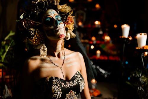 Woman Dressed as a Catrina Standing among Decorations