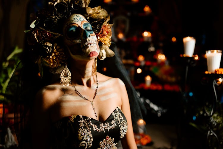 Woman Dressed As A Catrina Standing Among Decorations