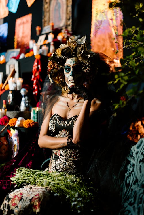 Woman Dressed as a Catrina Standing among Decorations 