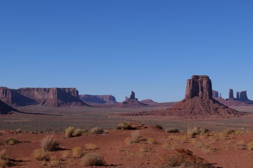Free Capture the grandeur of Monument Valley's majestic rock formations under a clear blue sky. Stock Photo