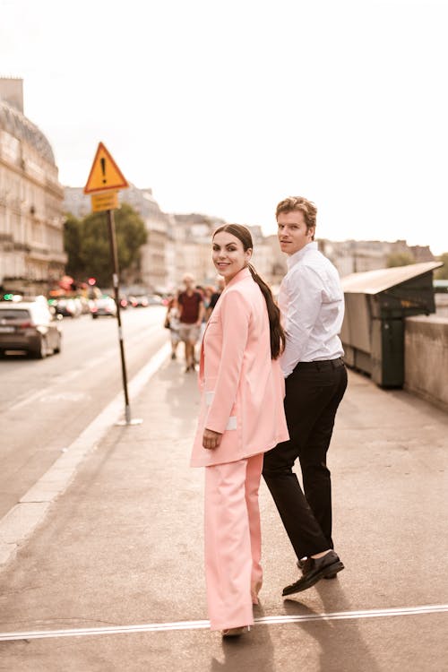Elegant Couple Walking on the Pavement in City 