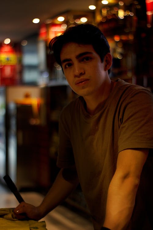 Young Man in a T-shirt Standing in a Bar