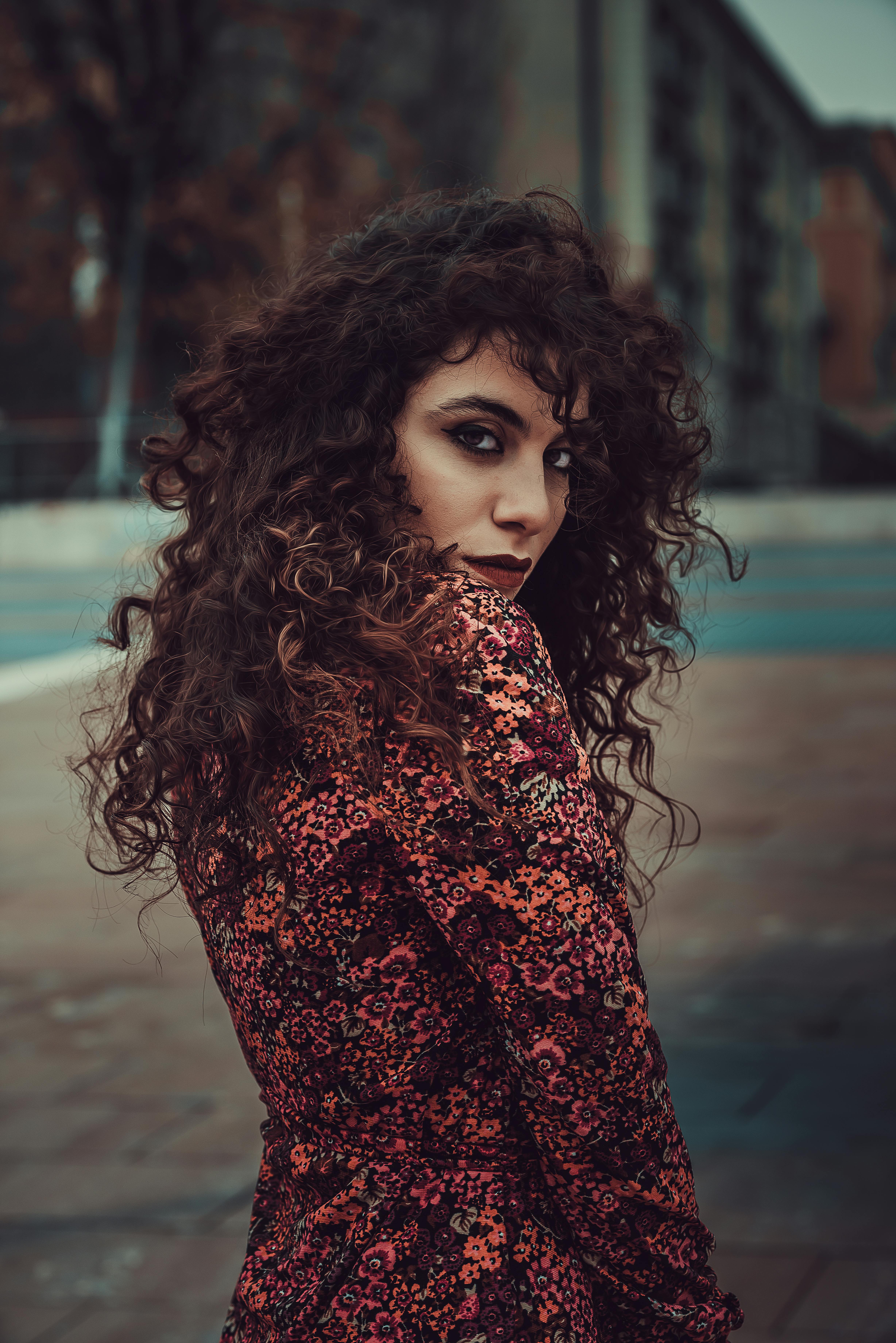 Photo Of Woman In White Sweater Sitting On Concrete Riverbank Images, Photos, Reviews