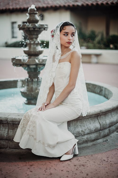 Bride Sitting on Fountain