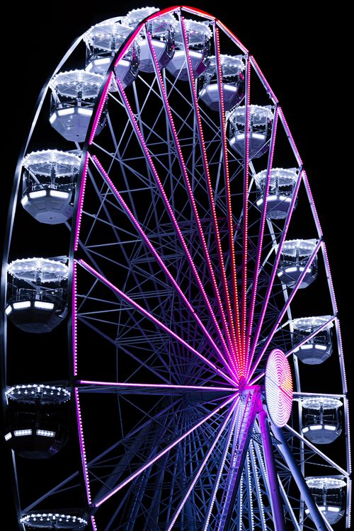 Free A dazzling ferris wheel brightly lit against the night sky, capturing urban nightlife excitement. Stock Photo