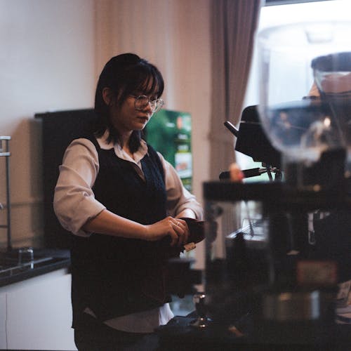 Woman in Eyeglasses Working in Cafe