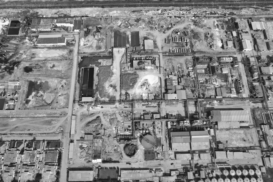 Residential township under construction near an industrial zone in Boisar, Maharashtra, showing housing development alongside manufacturing facilities