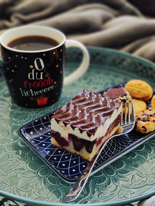 Black Coffee in Mug and Dessert on Table